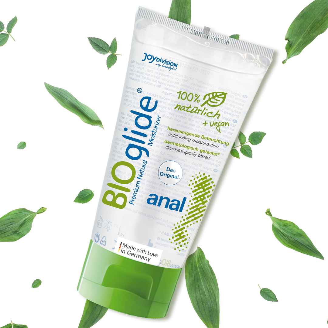Tube of BIOglide anal lubricant with green leaves on a white background
