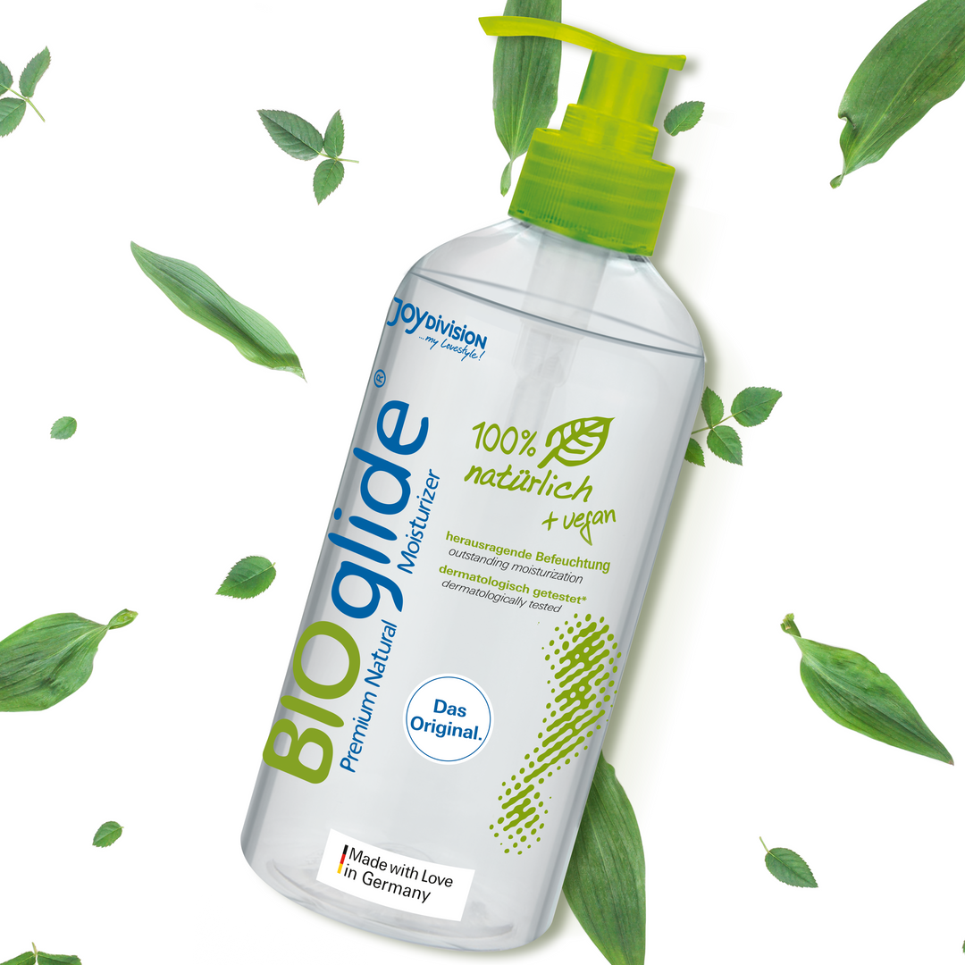 BIOglide moisturizer bottle with green leaves on a white background