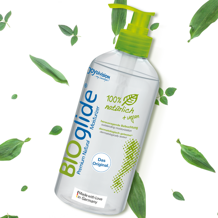 BIOglide moisturizer bottle with green leaves on a white background